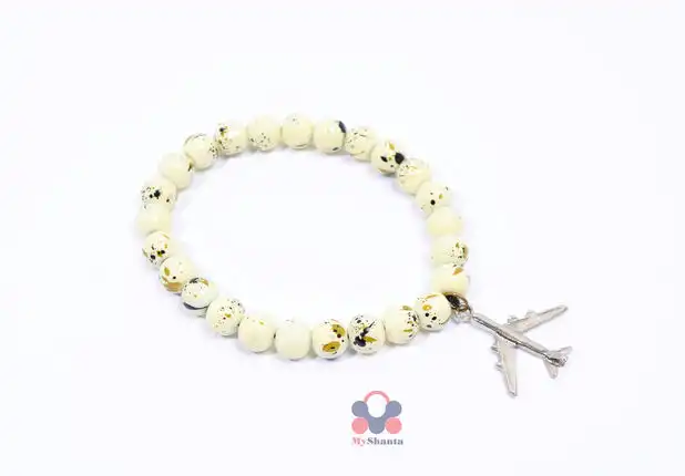 A hand bracelet with a marble character and a multi-colored plane symbol